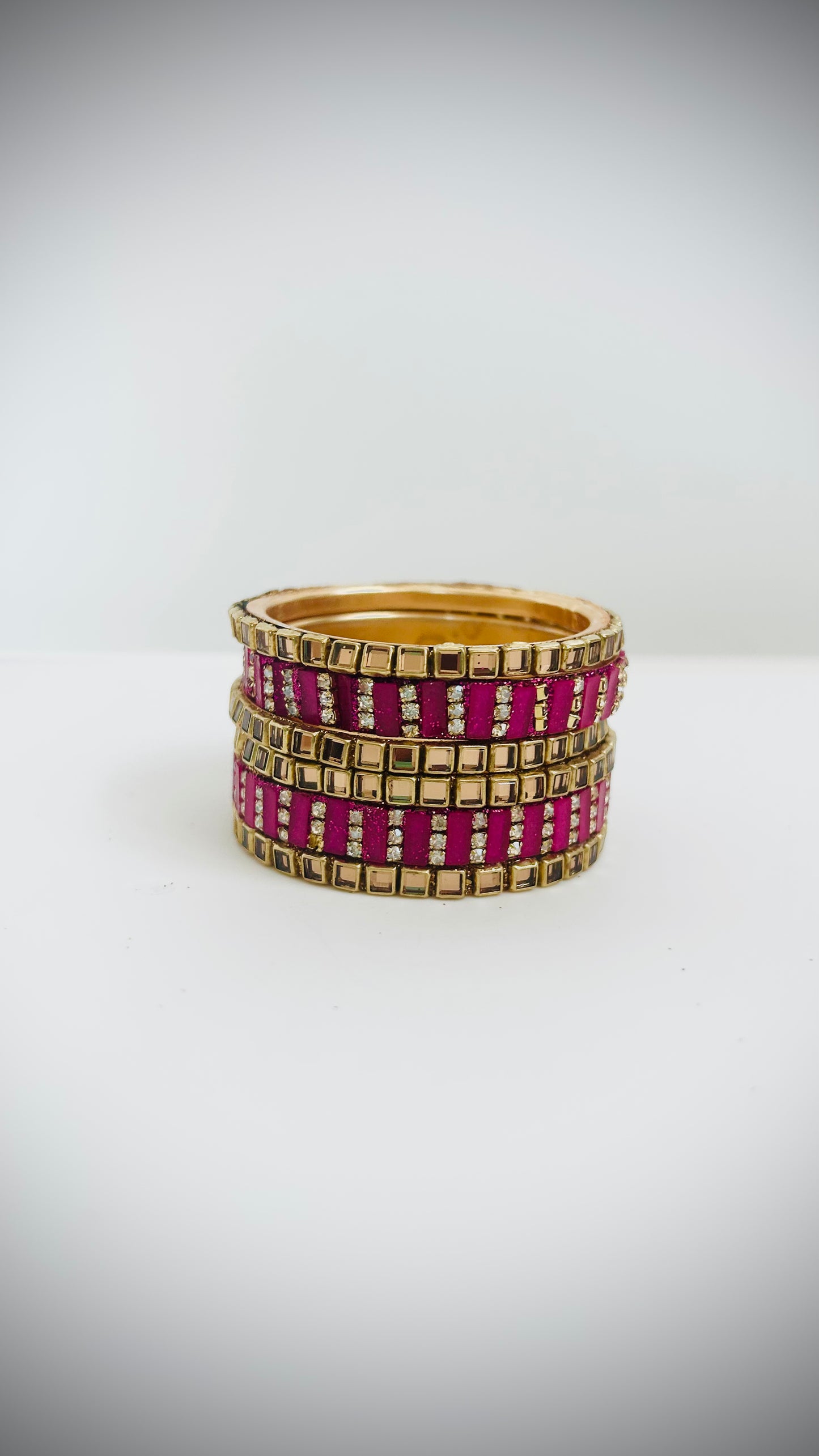 Set of 6 pink and gold desi bangles for children.