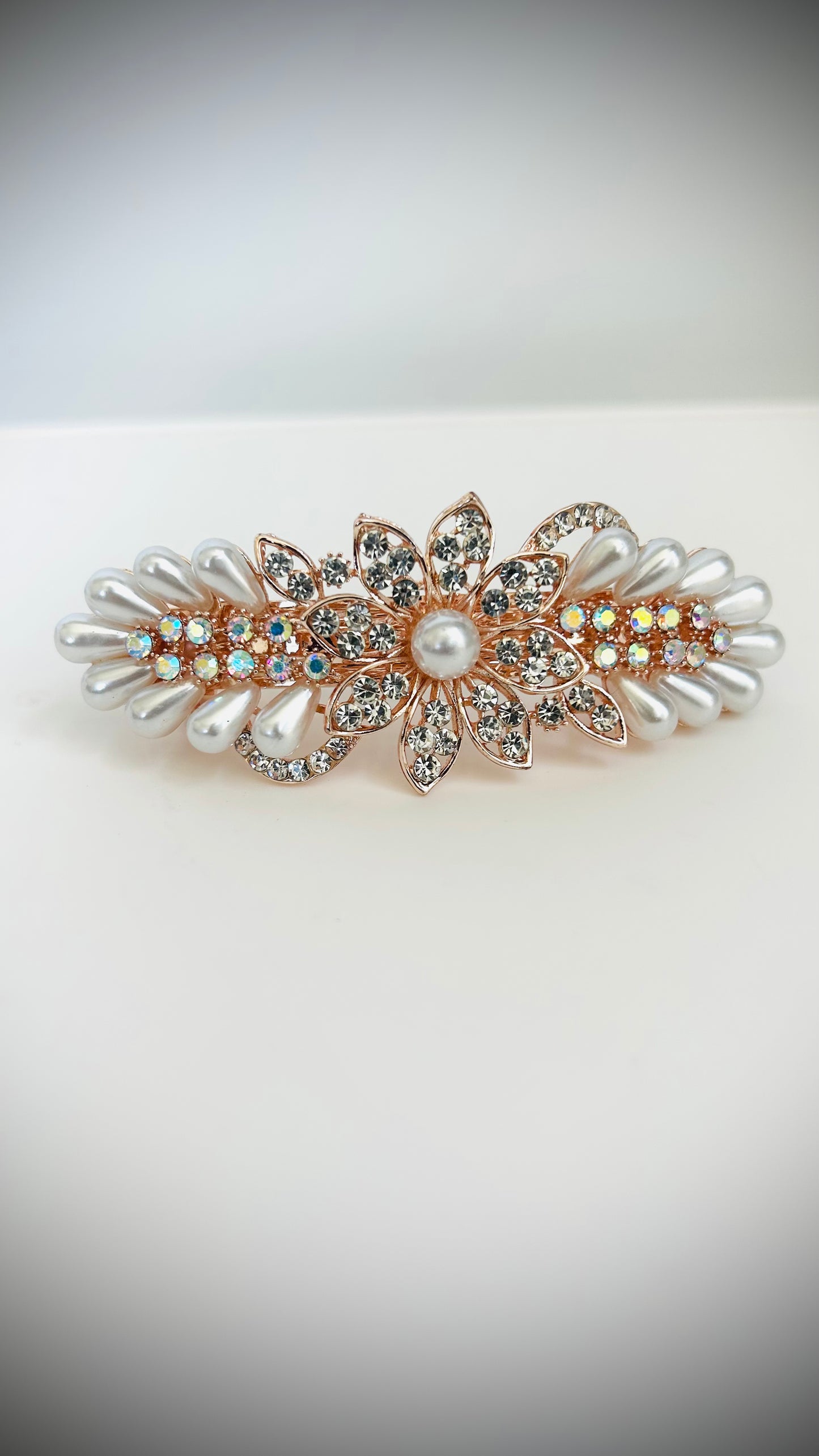 Decorative hair clip with pearls and crystals on a white background
