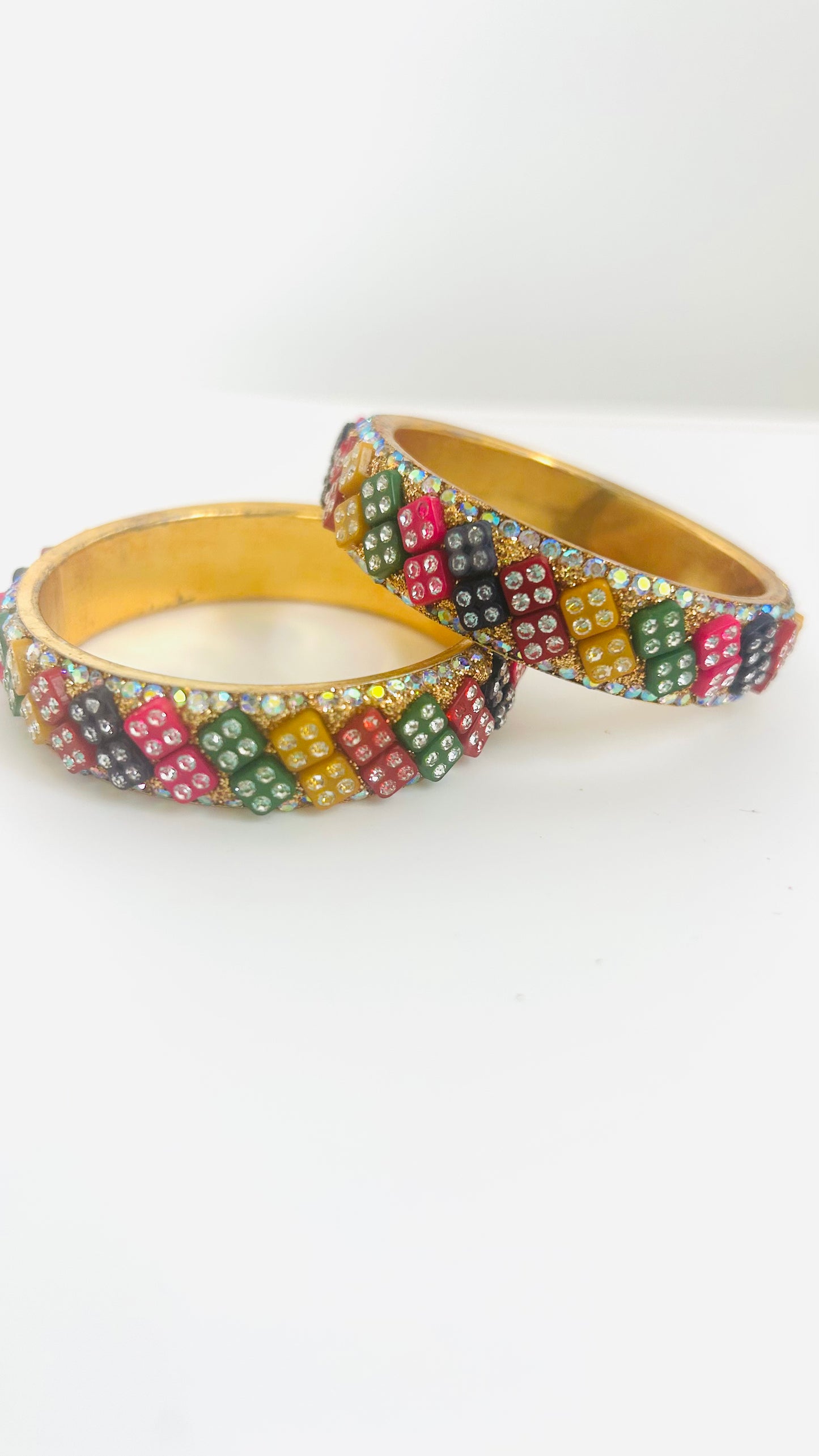 Two colorful beaded kids' bangles on a white background