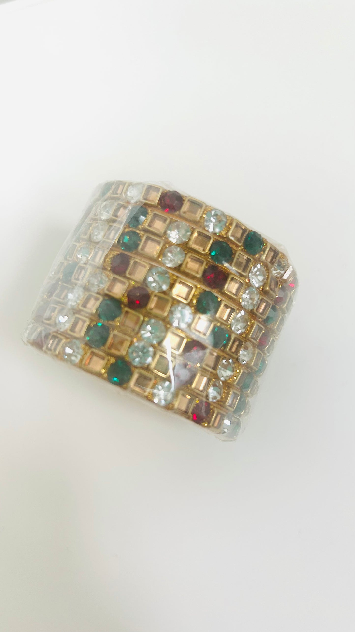 Multicolored gemstone bangles on a white background