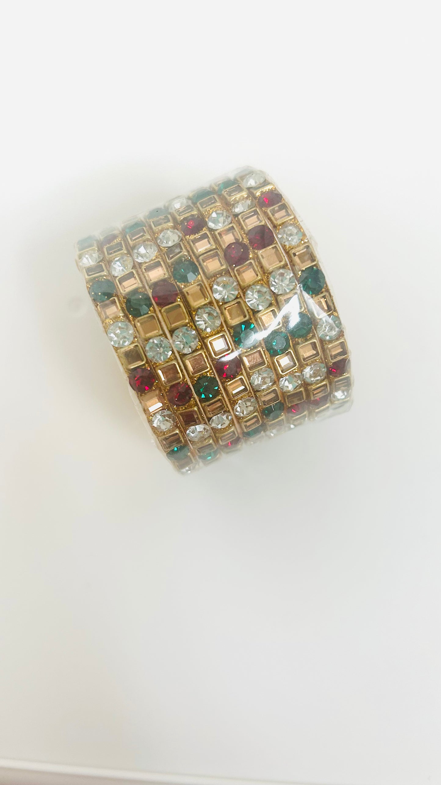 Multicolored gemstone bangles on a white background