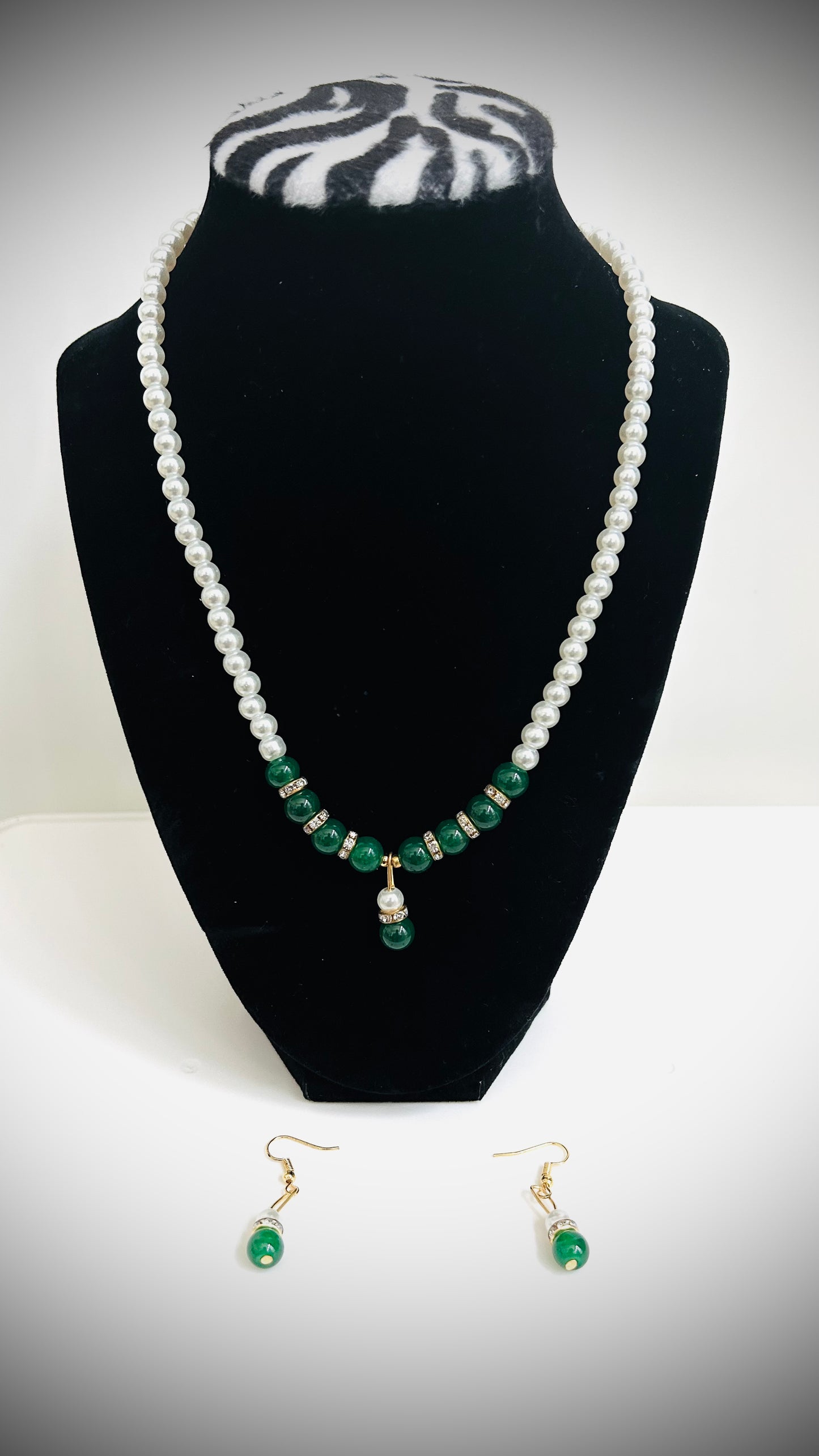 Single-layer white pearl necklace with green pendant, green beads, and matching earrings – traditional Desi jewelry set