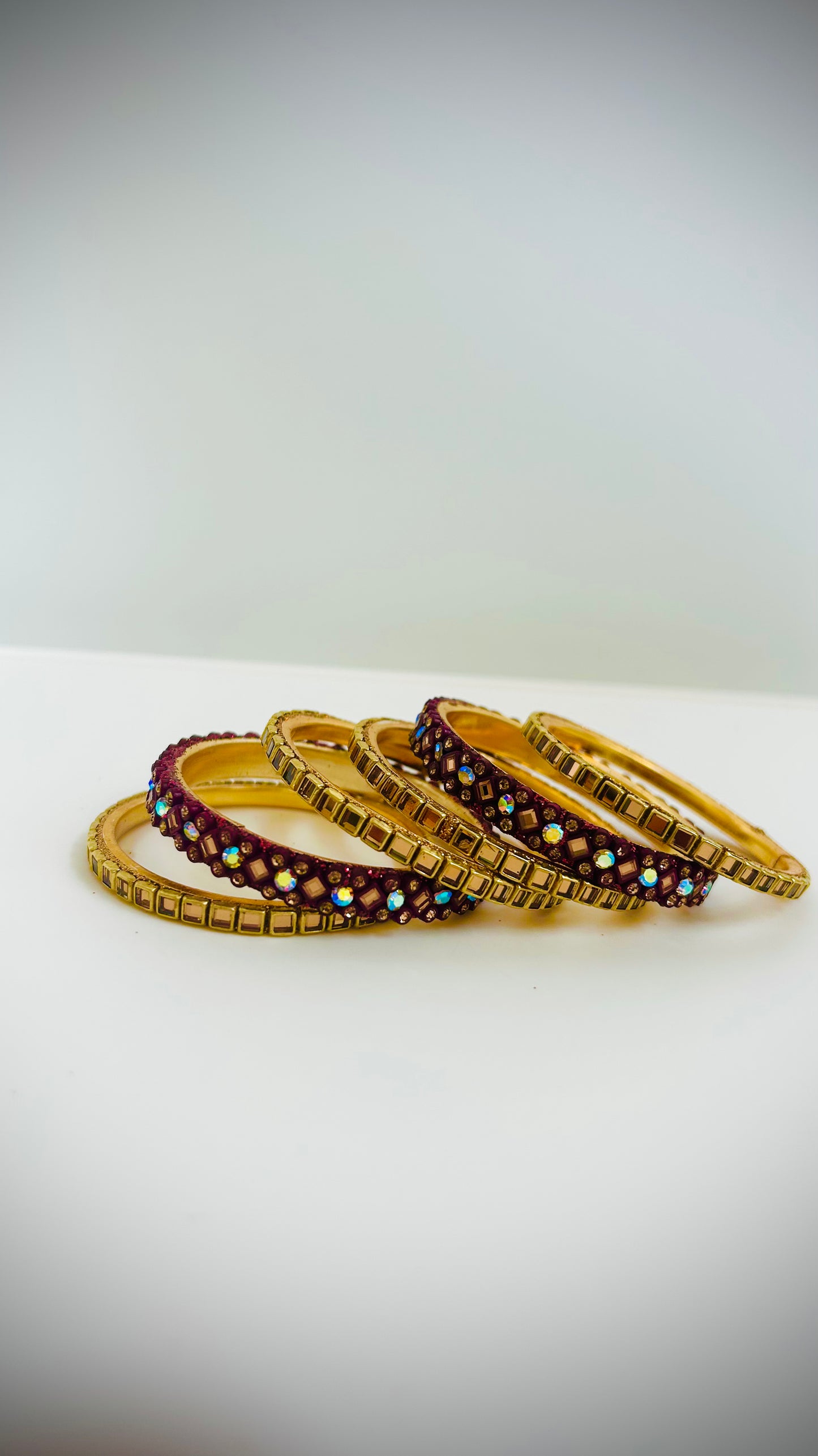Set of gold and maroon bangles 