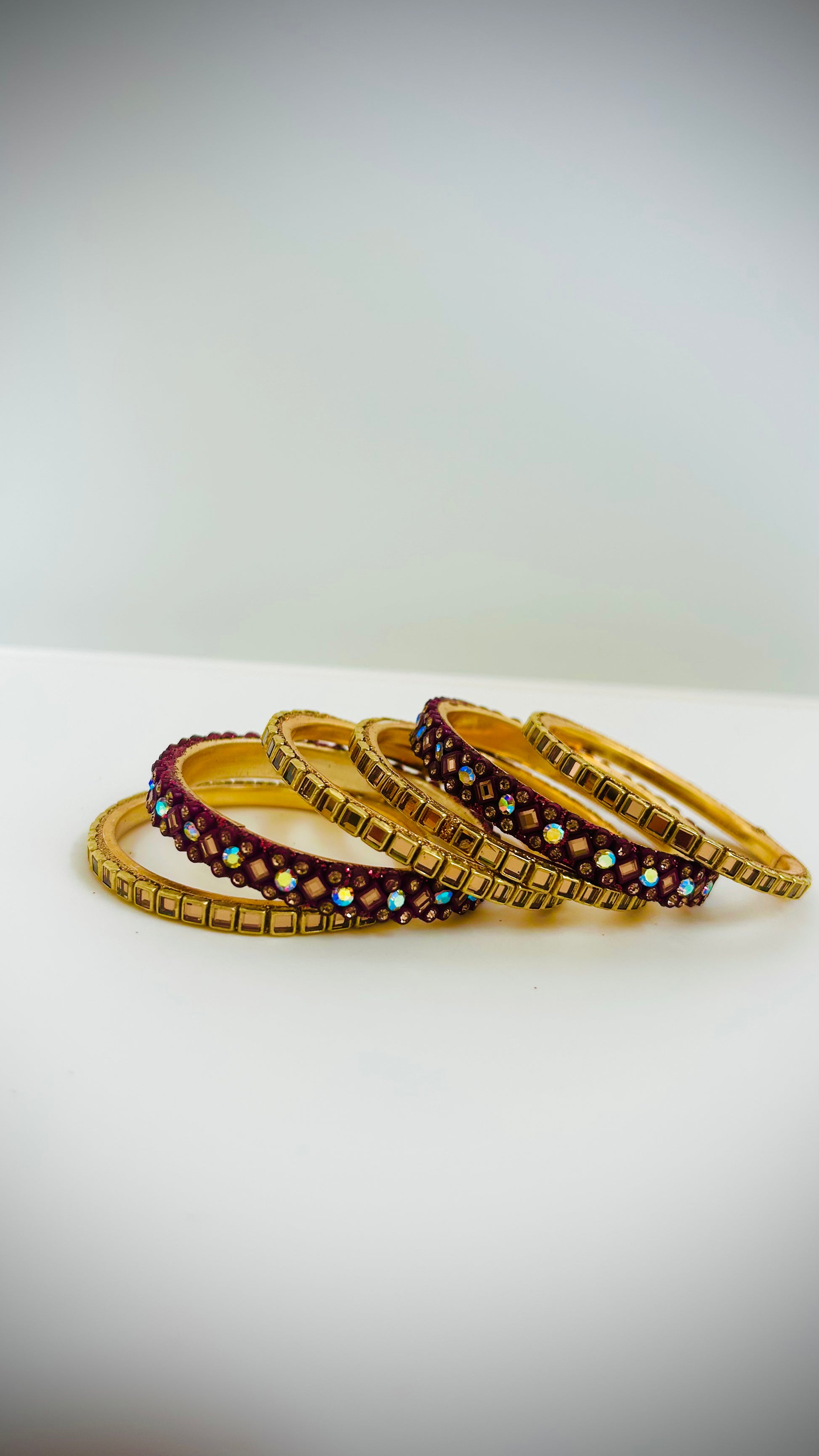 Set of gold and maroon bangles 