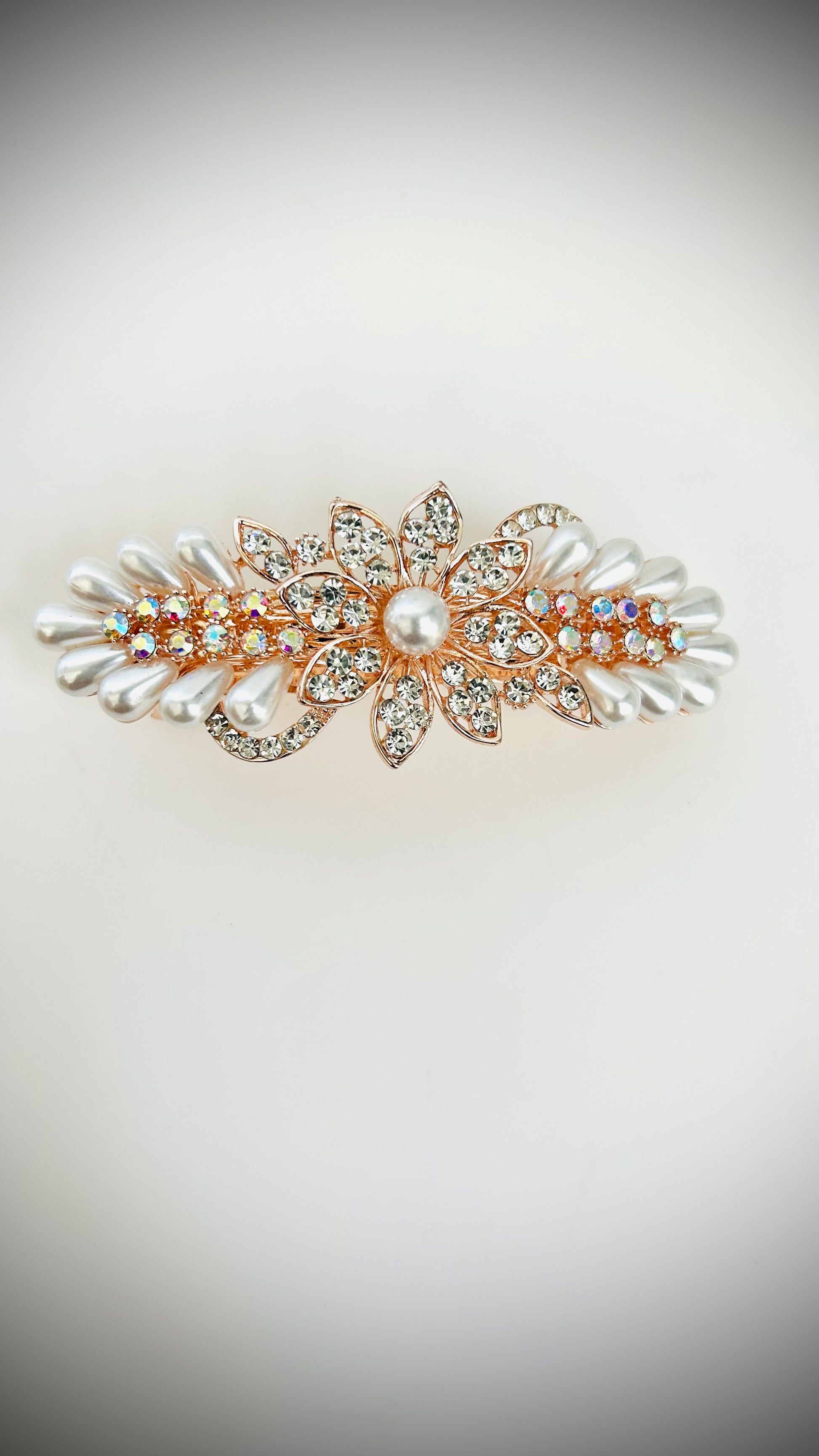 Decorative hair clip with pearls and crystals on a light background