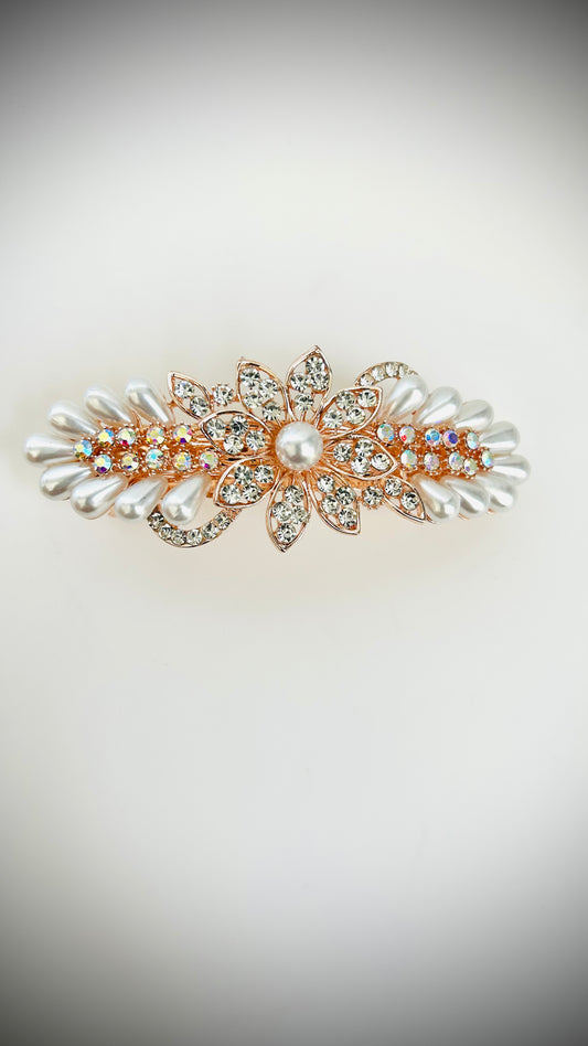 Decorative hair clip with pearls and crystals on a light background