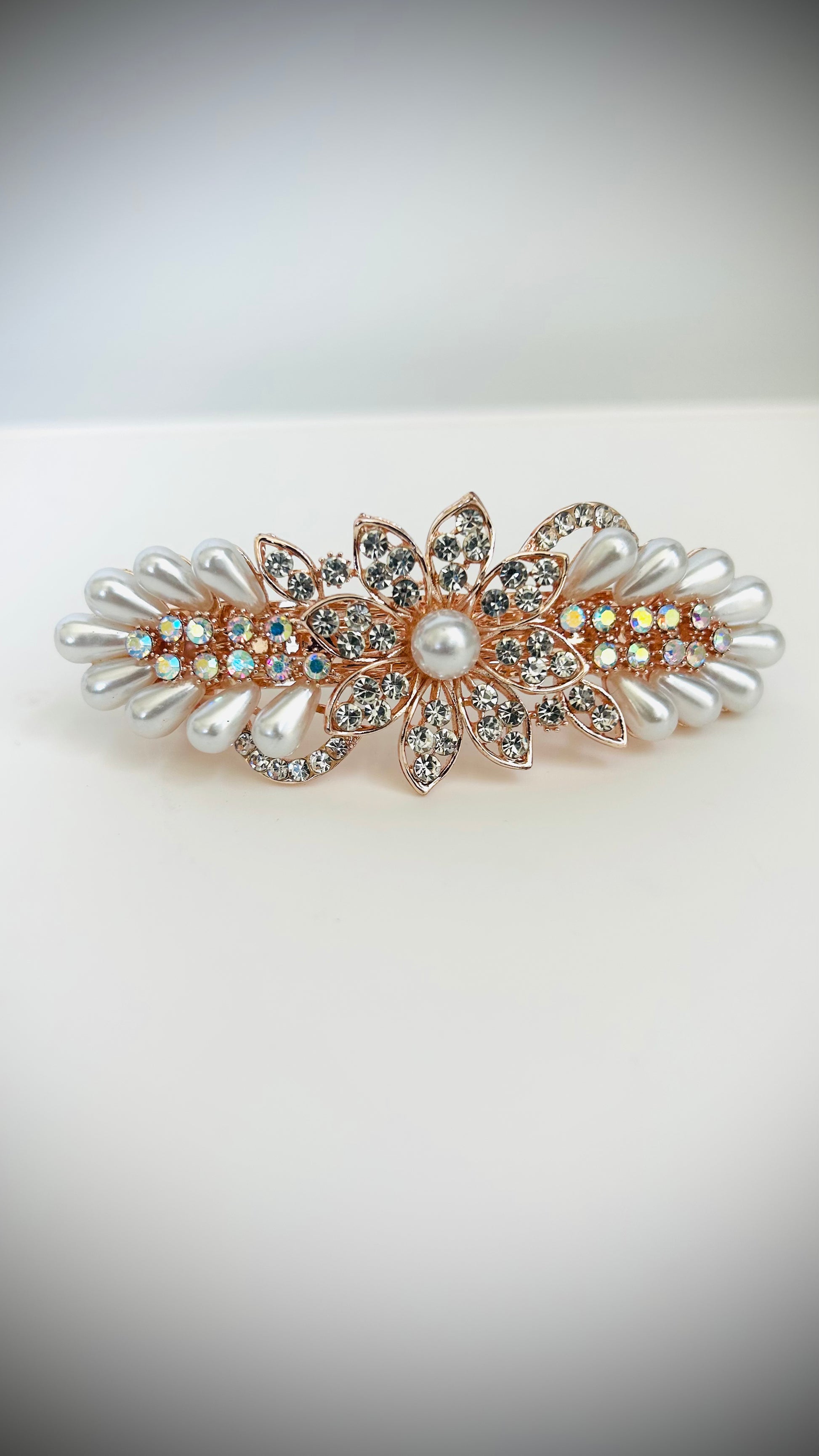 Decorative hair clip with pearls and crystals on a white background