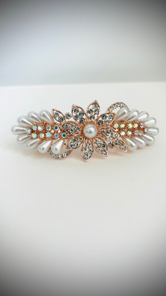 Decorative hair clip with pearls and crystals on a white background