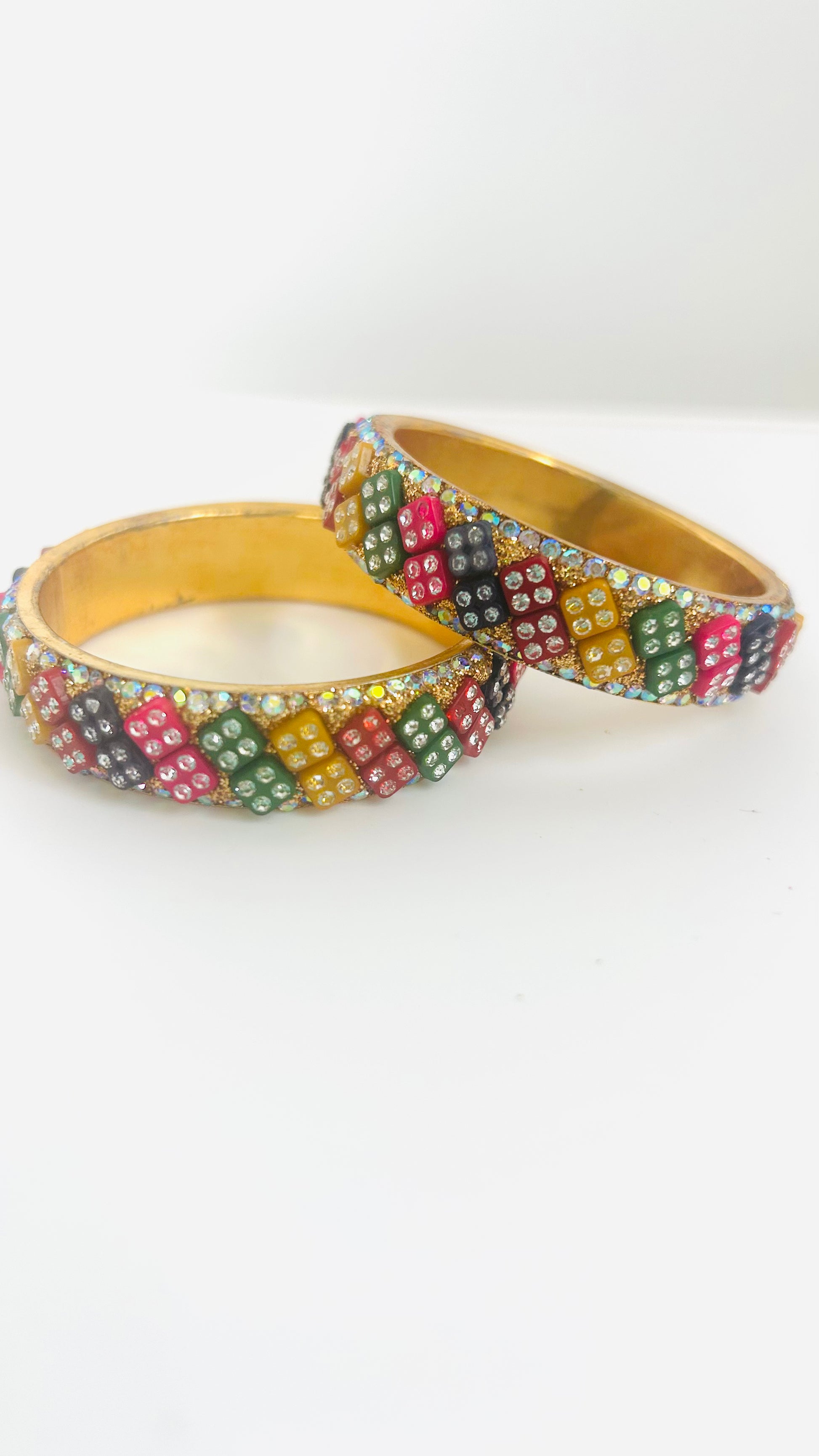Two colorful beaded kids' bangles on a white background
