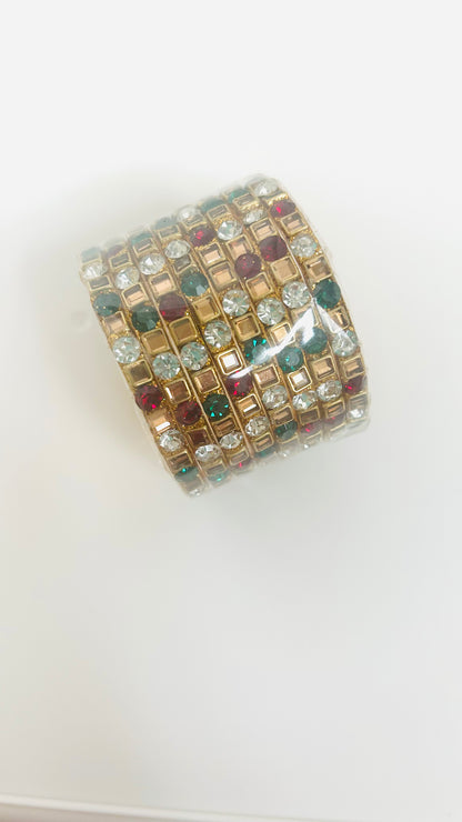 Multicolored gemstone bangles on a white background