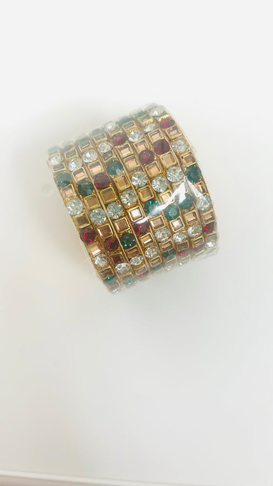 Multicolored gemstone bangles on a white background