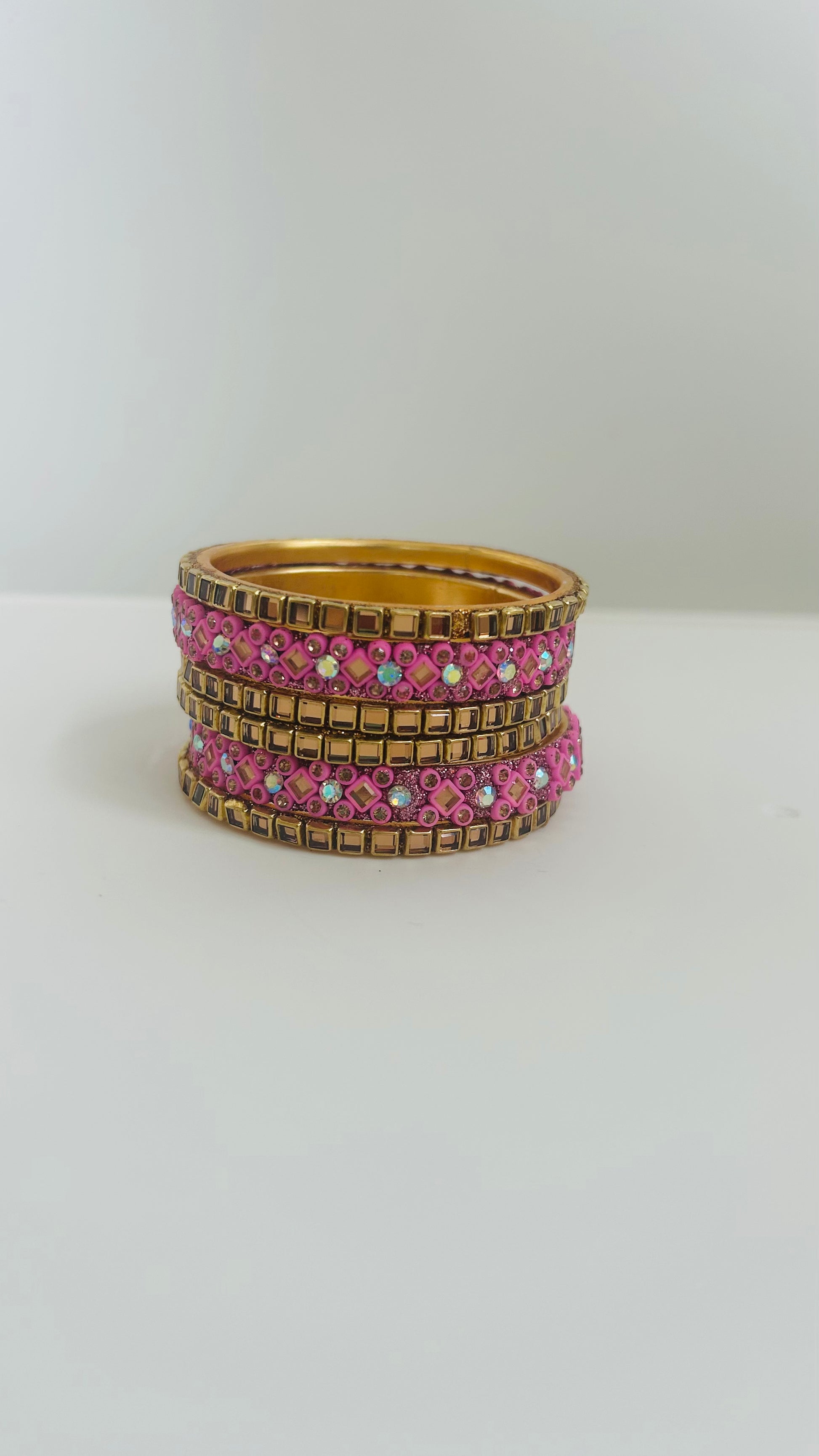 pink and gold bangles stacked