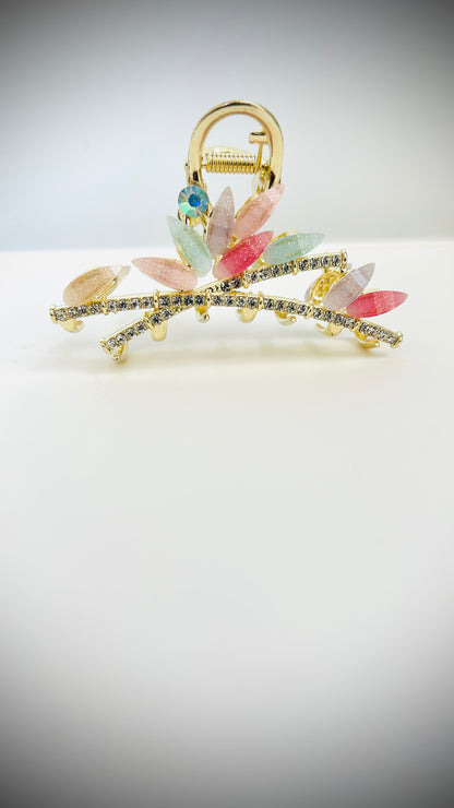 Decorative hairclip with colorful stones on a light gray background