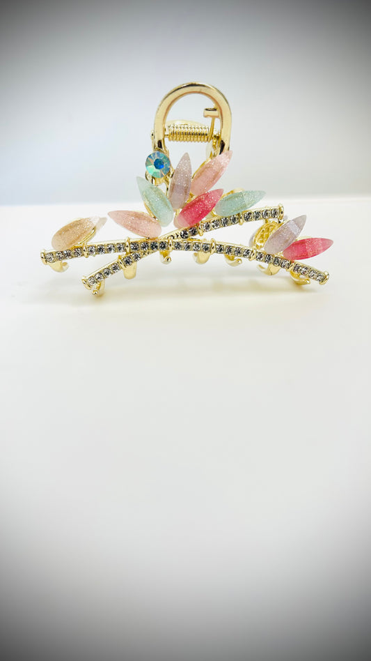 Decorative hairclip with colorful stones on a light gray background