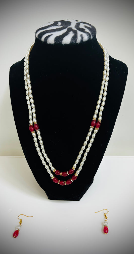 Double-layer white pearl necklace with red bead accents and matching red earrings – traditional Desi jewelry set