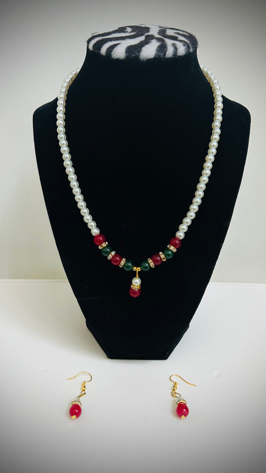 White pearl necklace with red pendant, red and green beads, and matching red earrings – traditional Desi jewelry set