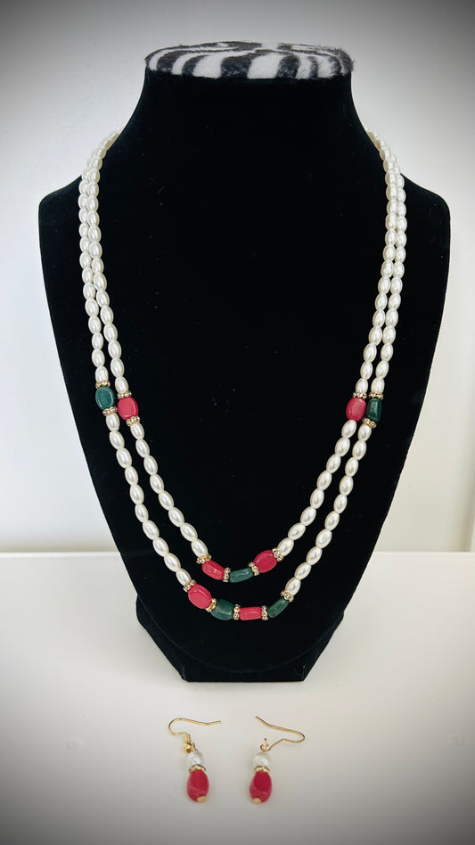 Glossy white double-layer pearl necklace with red and green bead accents and matching red earrings – traditional Desi jewelry set